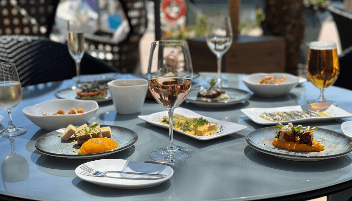 Wine glass on a table surrounded with food